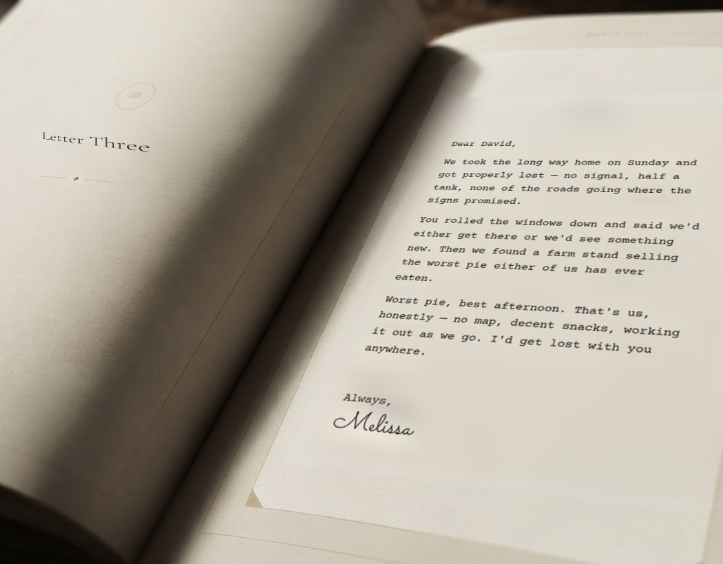 The finished book lying open — a divider page reading Letter Three on the left, and Melissa’s letter to David, signed by hand, on the right